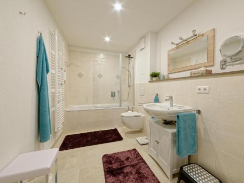 a white bathroom with a sink and a toilet at Huberhof Meisham in Eggstätt