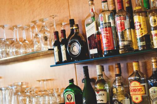 a shelf filled with lots of bottles of alcohol at Rugs Hotel Düsseldorf in Düsseldorf