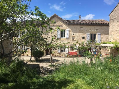a stone house with a garden in front of it at Puechblanc Gîtes et Chambre d'hôte dans le Triangle d'or Gaillac-Albi-Cordes sur Ciel in Fayssac