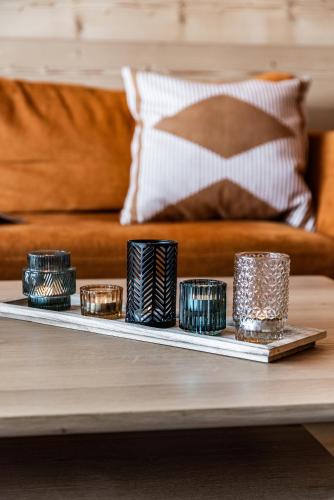 a tray with candles on a table in front of a couch at Apartment Wapa Alpe d'Huez - by EMERALD STAY in L'Alpe-d'Huez