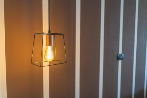 a light hanging on a wall with a door at Hotel Continental in Reggio Calabria