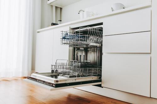 a kitchen with metal dishes in a dishwasher at 54 São Paulo - Exclusive Apartment Hotel in Lisbon