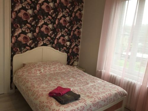 1 dormitorio con 1 cama y papel pintado con motivos florales en La Vie est Belle, en Abbeville