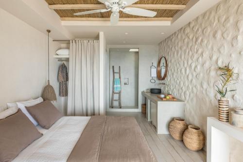 a bedroom with a bed and a ceiling fan at Verina Astra in Artemonas