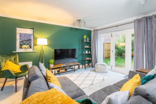 a living room with a couch and a tv at 9 College Court Spacious, Modern 4-Bed Townhouse in York - Pass the Keys in York