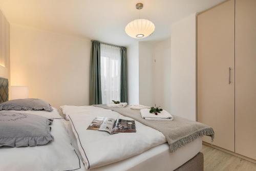 a bedroom with two beds and a window at Apartmenthaus Am Park Am Park 23 in Prerow