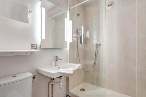 a bathroom with a sink and a shower at B&B HOTEL Louveciennes in Louveciennes