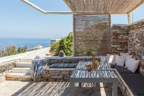 a patio with a couch and a table at Verina Astra in Artemonas