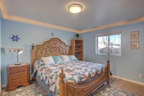 a bedroom with a bed with a wooden frame and a window at Farr West Apartment on Farm Less Than 25 Mi to Ski Resorts 