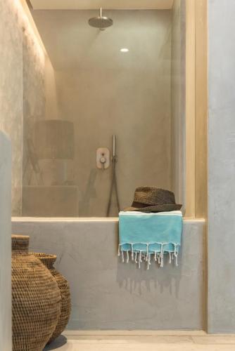 a bathroom with a bath tub with a blue towel at Verina Astra in Artemonas