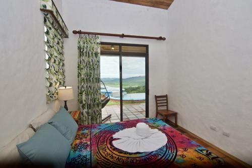 a bedroom with a bed with a table and a window at Serenity House Panoramic Views And Swimming Pool, in El Castillo de la Fortuna