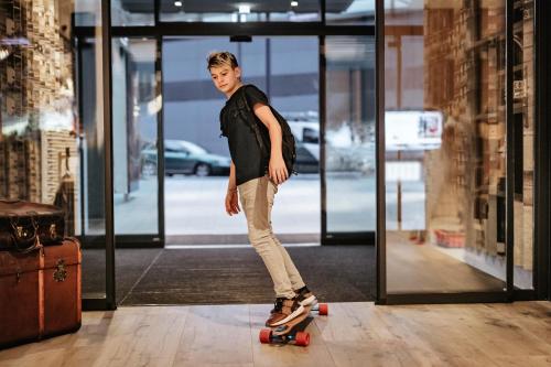 a young man riding a skateboard in a building at ibis Hotel Hannover City in Hannover