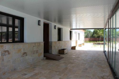 an empty hallway of a building with a large window at Casas Rurales Laguna La Tinaja in Ossa de Montiel