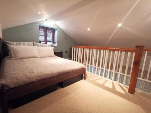 a bedroom with a bed in a attic at Three Peaks View Cottage BD23 4SP in Wigglesworth