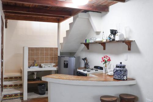 a kitchen with a stove and a counter top at Hostal & Suites Pata de Perro in Bacalar