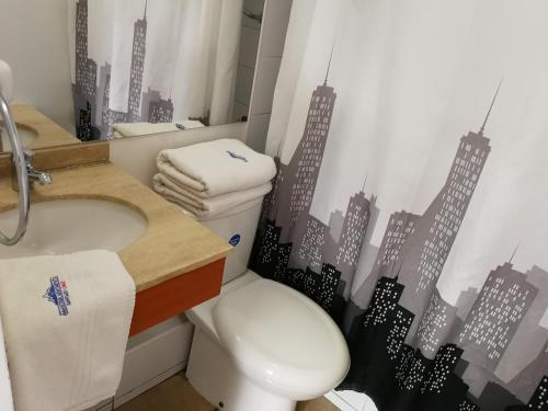 a bathroom with a toilet and a sink at Santiago Center Apart in Santiago