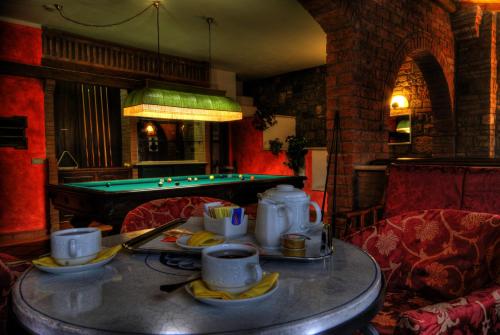 a table in a room with a pool table at Casanova - Panoramic Rooms and Suites in San Quirico dʼOrcia