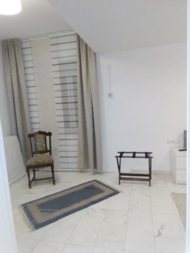 a living room with a chair and a rug at Villa Bellevue in Waldkappel