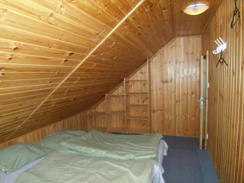a bedroom with a bed in a wooden cabin at Chata Morávka Rejdice in Kořenov