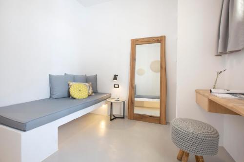 a room with a blue bench and a mirror at Kouros Village in Antiparos Town
