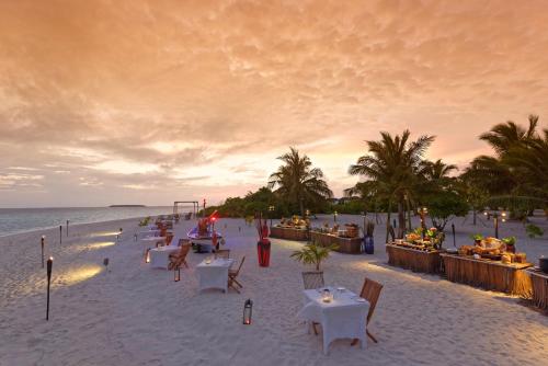 a beach with tables and chairs on the beach at NH Collection Maldives Havodda Resort - Stays of 6 nights or more, 50 percent off domestic flights for 2 person in Gaafu Dhaalu Atoll