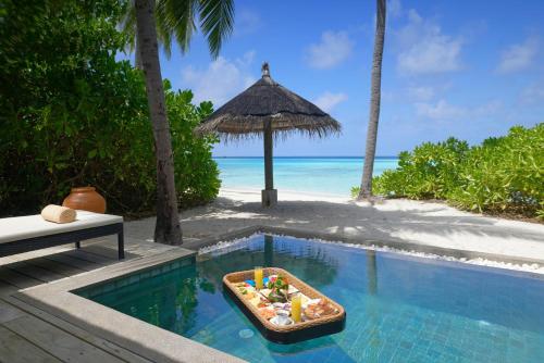 a tray of food in a pool next to a beach at NH Collection Maldives Havodda Resort - Stays of 6 nights or more, 50 percent off domestic flights for 2 person in Gaafu Dhaalu Atoll