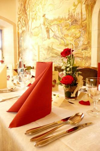 a table with a red napkin on top of a table at Waldgasthof Wildbad in Burgbernheim
