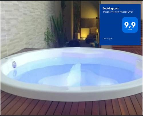 a large white bath tub in a room at casa spa in Rio das Ostras