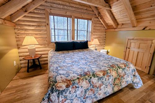 a bedroom with a bed in a log cabin at Ski S'More in La Follette