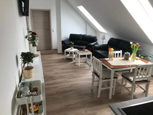 a living room with a table and a couch at FEWO Salzwedel, Zum Dorfplatz in Salzwedel