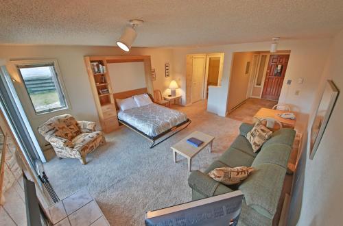 a living room with a couch and a bed at Timber Run Vista 2 in Winter Park