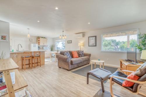 a living room with a couch and a kitchen at Sandy Feet in Nehalem