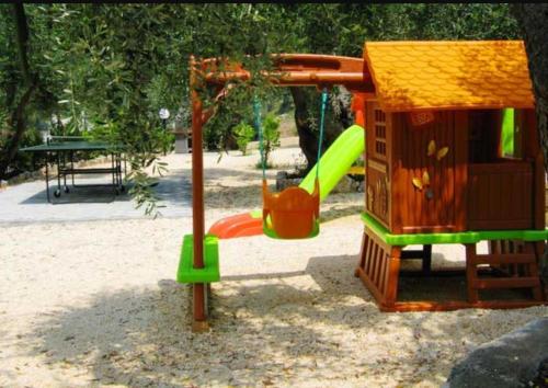 a playground with a play structure and a slide at Villa Rinaldi apartment in Vieste