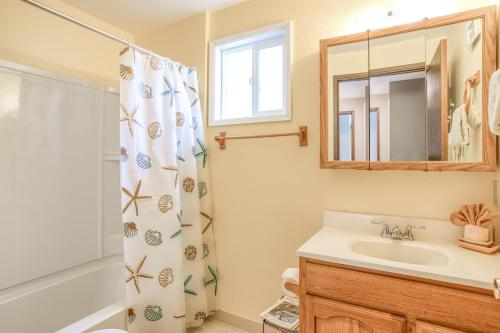 a bathroom with a sink and a shower curtain at 38445 Reed - Meredith Lodging in Manzanita