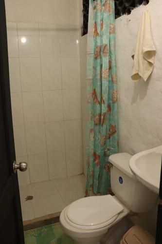 a bathroom with a toilet and a shower and a sink at Casa Blanca - Taganga in Santa Marta