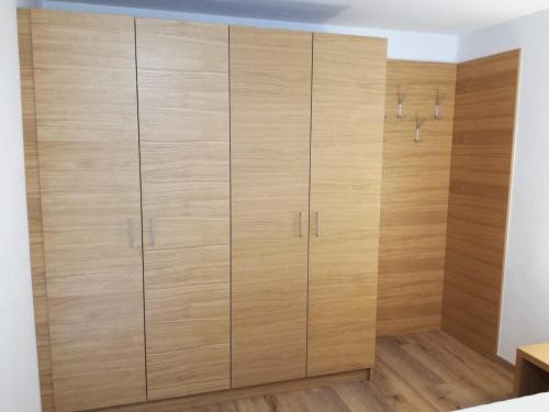 a large closet with wooden doors in a room at Haus Partoll in Kappl