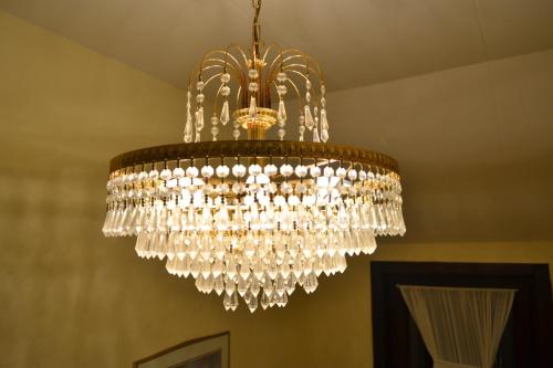 a large chandelier hanging from a ceiling at Hotel Plaza in Lommel