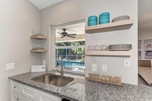 a kitchen with a sink and a window at Modern Home with Screened-In Pool 4 Mi to the Beach in Venice