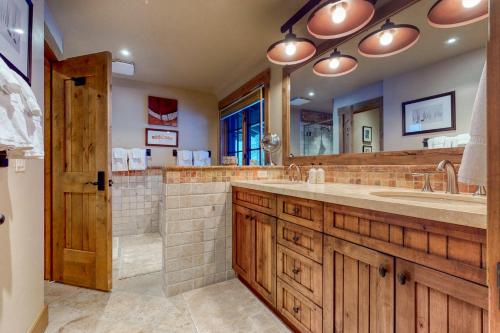 a bathroom with a large sink and a large mirror at Teton View Cabin in Jackson