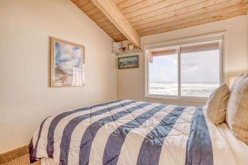 a bedroom with a bed and a window at Breakers Beach House 4 - Meredith Lodging in Neskowin