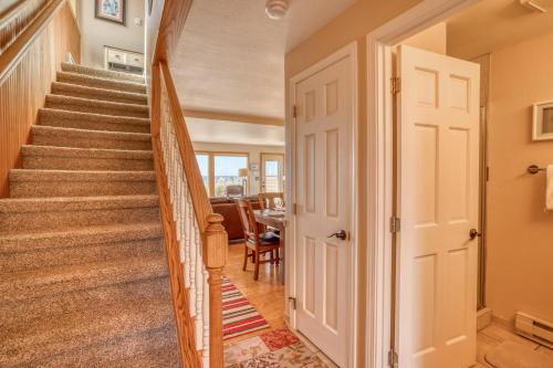 a staircase leading to a dining room and living room at Breakers Beach House 9 - Meredith Lodging in Neskowin