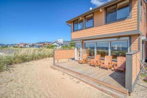 a house with a deck with chairs on the beach at Breakers Beach House 9 - Meredith Lodging in Neskowin
