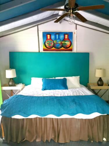 a bedroom with a blue headboard and a blue bed at CHEZ NOUS in Carrillo