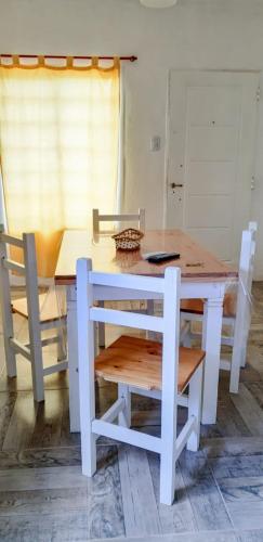 a table with two chairs and a table and a table and a table and chairs at La Soñada - cabañas in Cruz del Eje