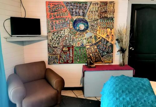 a room with a chair and a painting on the wall at CHEZ NOUS in Carrillo