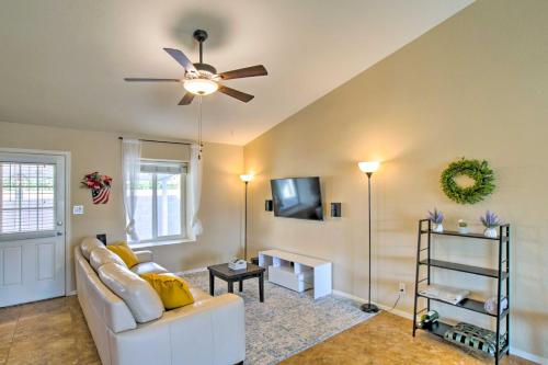 a living room with a white couch and a ceiling fan at Near Golf and Entertainment! Gilbert Family Getaway in Gilbert