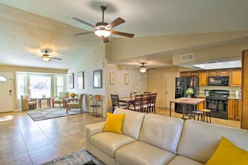 a living room with a white couch and a kitchen at Near Golf and Entertainment! Gilbert Family Getaway in Gilbert