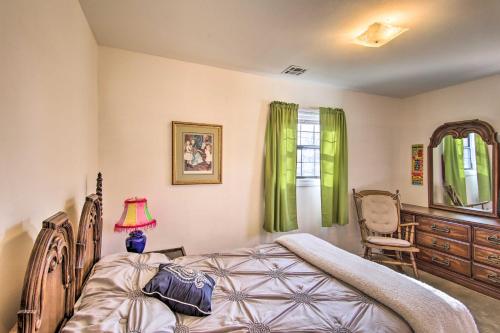 a bedroom with a bed and a chair at Dog-Friendly Bartlesville Retreat with Yard! in Bartlesville