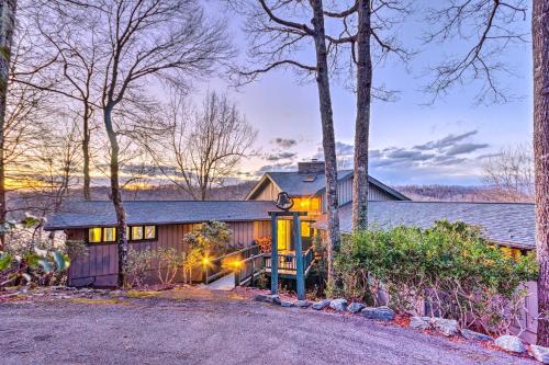 a home in the woods with a driveway at Brevard Home with Panoramic Lake and Mountain Views! in Brevard