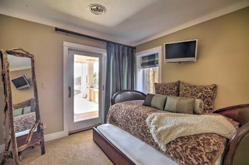 a bedroom with a bed and a tv on the wall at Waterfront Home on Norris Lake with Boat Slip! in La Follette